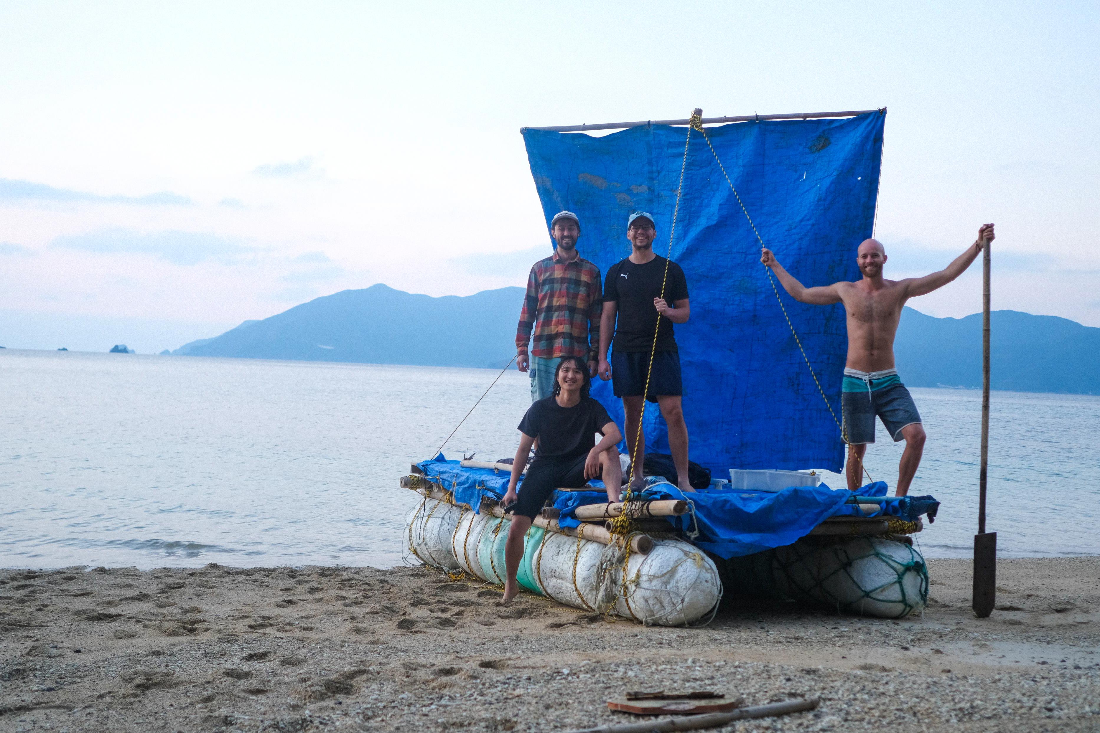 Four friends on the IKADA raft after arriving at Kakeromajima from Amami Oshima